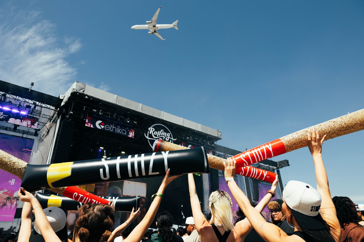 Rolling Loud crowd holding oversized STIIIZY inflatable joints in front of the main stage