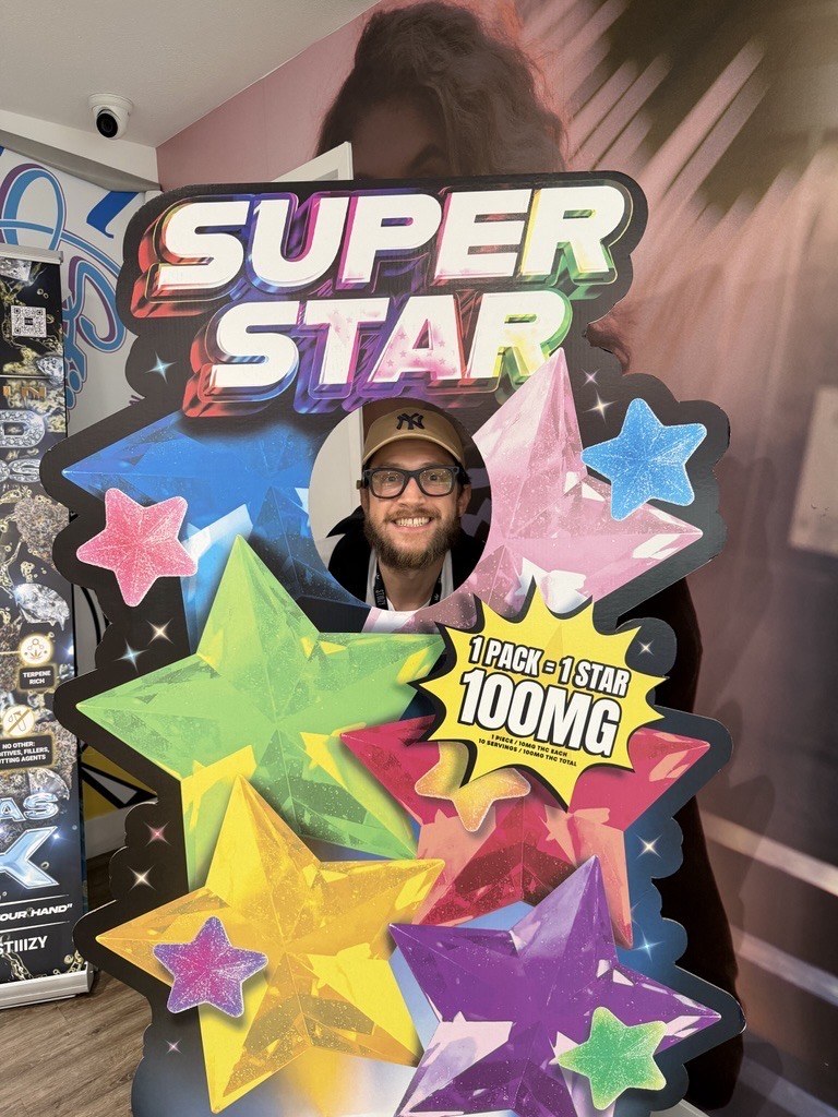 Super Star cardboard cutout in store with customer