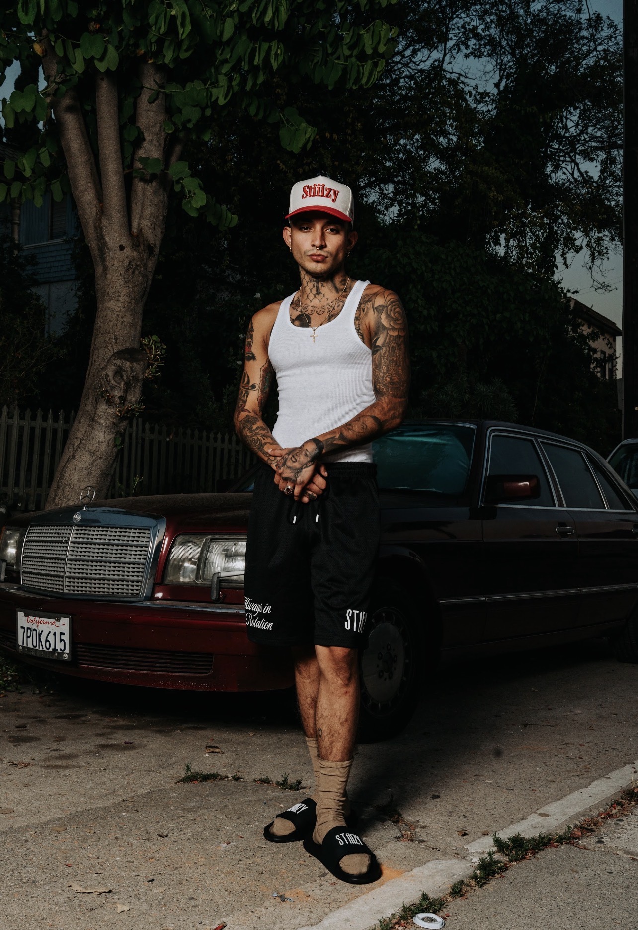 STIIIZY apparel photographed beside a Mercedes at night