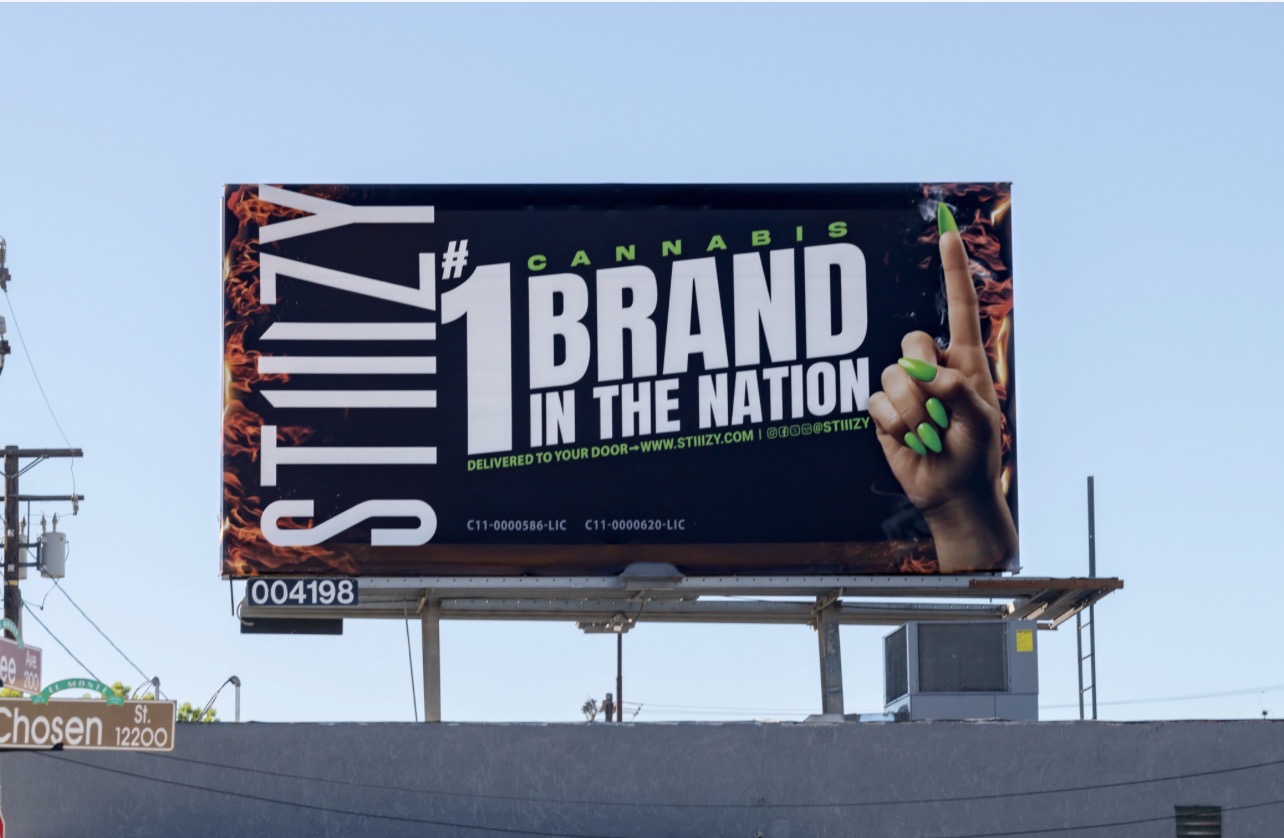 STIIIZY brand billboard featuring a raised finger with green nails