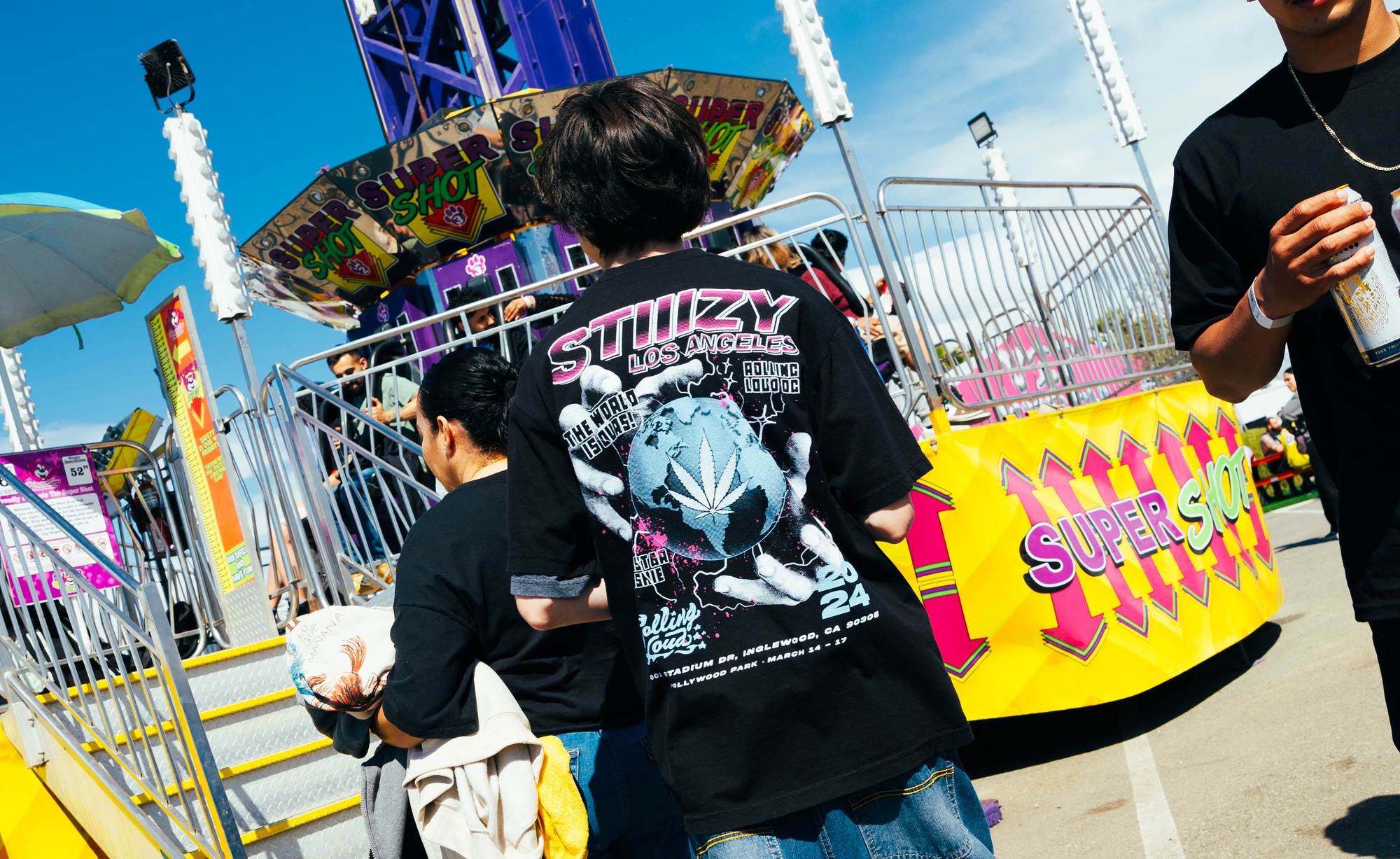 2024 collaboration tee photographed from the back at the festival