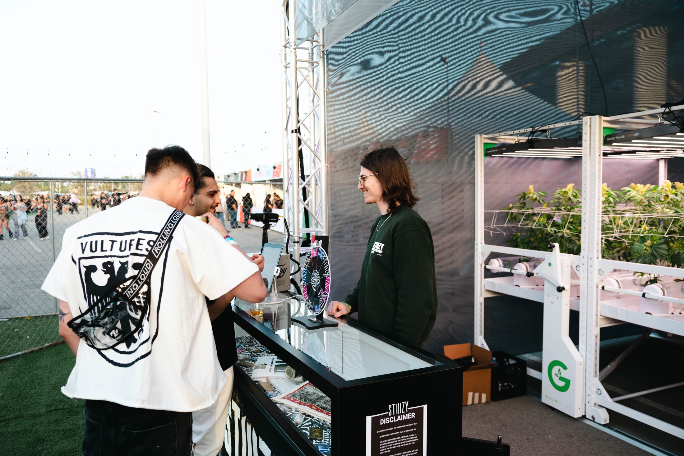 2024 visitors at the product counter beside the illuminated plant racks